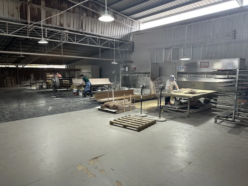 Finishing workshop with hotel furniture components and production staff