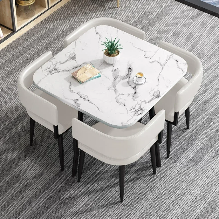 Square marble-look table with four cream faux-leather chairs, top-down view