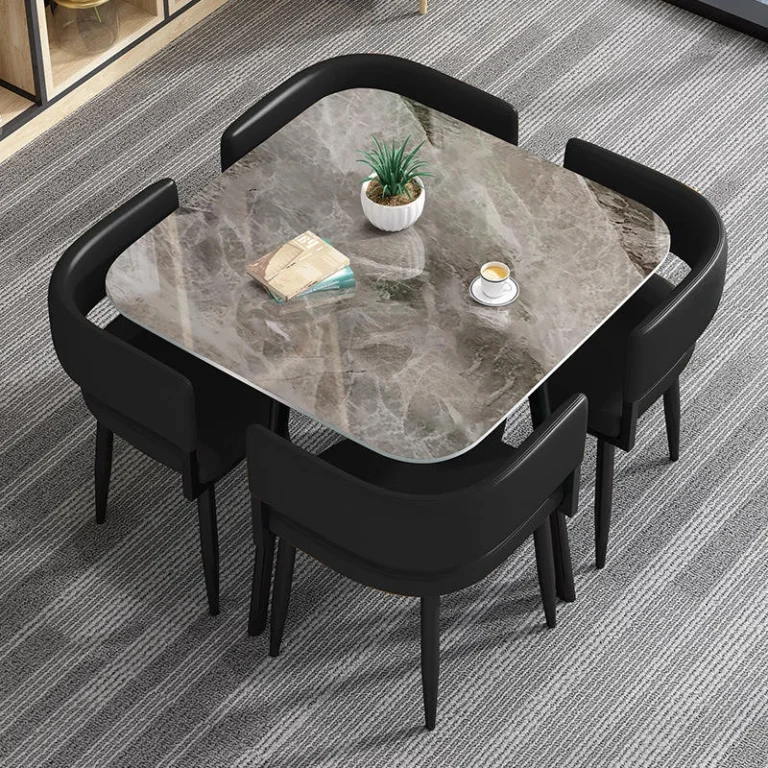 Square grey marble-look table with four black chairs, top-down view