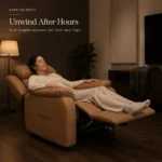Woman lying back in the recliner with the full-length footrest raised, in a dim living room