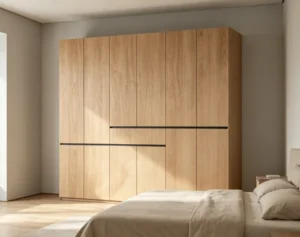 Full-height light oak-tone wardrobe with flush doors and slim black horizontal lines, beside a bed in a bedroom