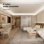 Wide room view with TV wall, desk with chair, bed, cream sofa and round coffee table on a gray rug