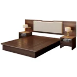 Walnut-tone platform bed with wall headboard panel, cream padded centre and two open-shelf nightstands with lamps, on white