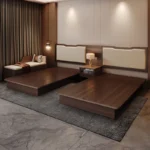 Two walnut-tone platform bed bases side by side with matching headboard panels, a nightstand between and a bench at the side
