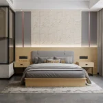 Gray padded bed with a light-oak base and backboard, one-drawer bedside tables and a stone-look feature wall with copper trim
