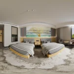 Wide-angle view of twin beds with gray headboards, a bedside table between them and two chairs by the window