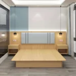 Light-oak platform bed base with a pale blue padded headboard and two open-shelf nightstands