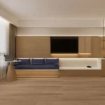 TV wall with a long white ledge, a bench with navy cushions and a round table with a wood cone base
