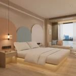 Bed seen from the side with a bedside table, arch-shaped wall panels and a daybed by the window