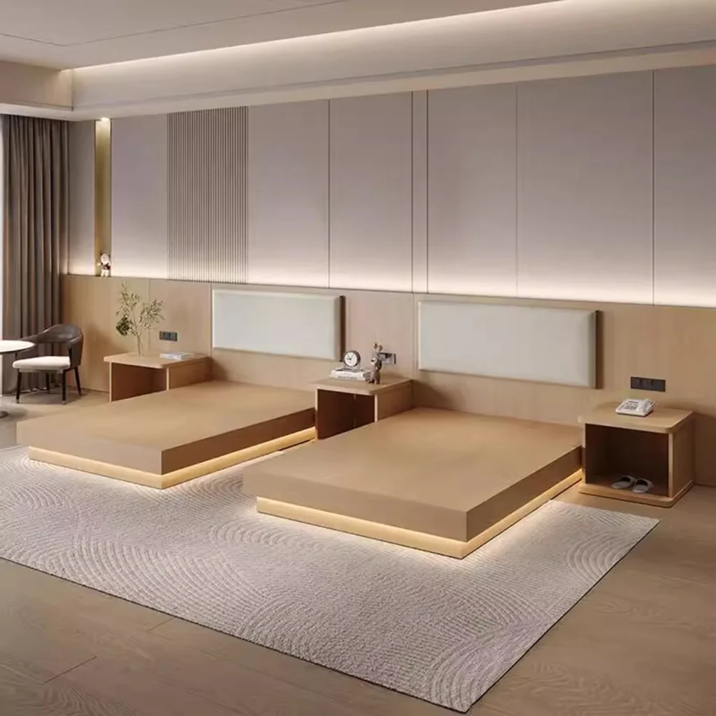 Two light-wood platform bed bases with cream padded headboards, open-shelf nightstands and a warm glow under the bases