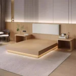 Light-wood platform bed with a cream padded headboard and two wood nightstands on a patterned rug