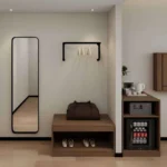 Black wall clothes rail, a full-length mirror, a bench with a shoe shelf and a mini-bar cabinet with a safe