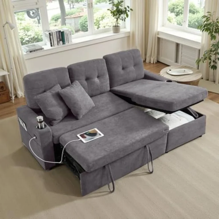 Gray L-shaped sleeper sectional with the bed pulled out and the storage chaise open