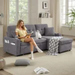 Gray sectional in a living room with a woman reading and a cat on the seat