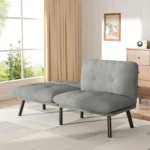 Gray velvet loveseat with one backrest folded down, in a bright living room
