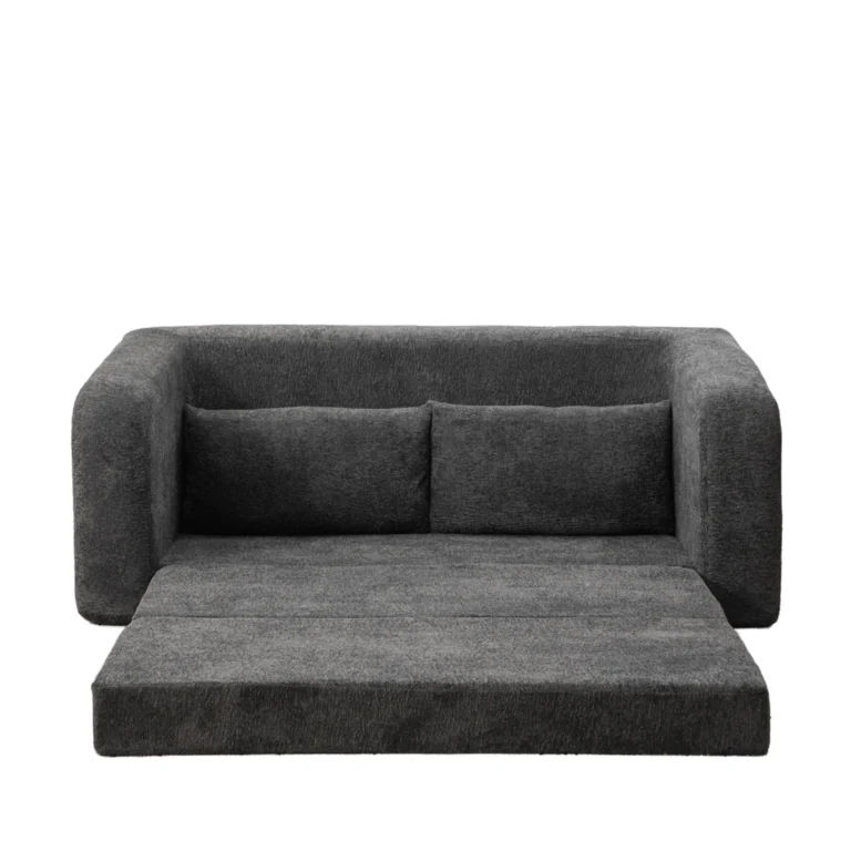 Dark gray frameless foam sofa with the seat unfolded into a floor mattress