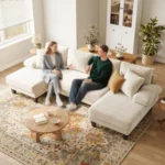 Two people talking on the cream U-shaped sectional