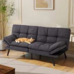 Gray tufted futon with a cat asleep on the seat