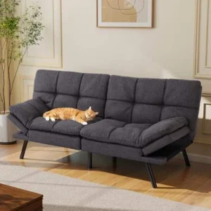 Gray tufted futon with a cat asleep on the seat