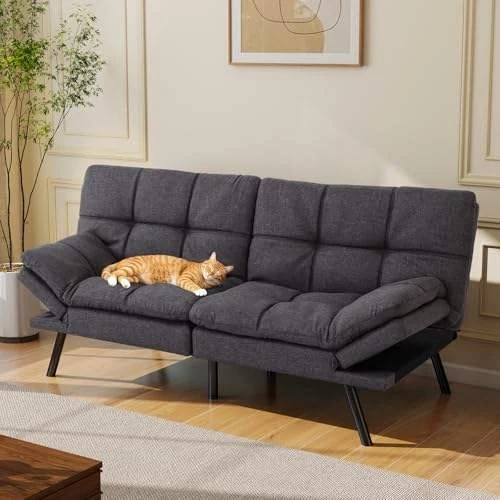 Gray tufted futon with a cat asleep on the seat