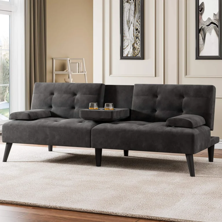 Charcoal tufted futon with the center console folded down holding two glasses