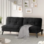 Black velvet armless futon with a throw in a bright living room