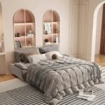 Sofa opened as a queen bed with bedding in a bedroom