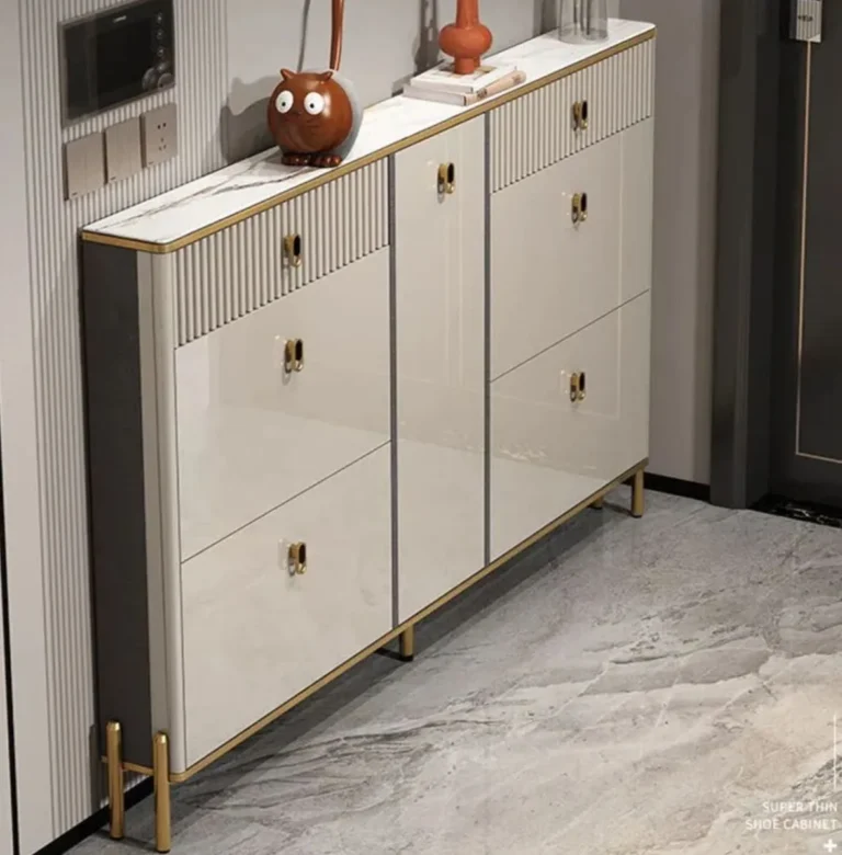 Slim champagne cabinet in two units with fluted drawers, gold-tone pulls, a stone-look top and gold legs