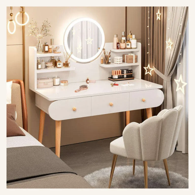 White vanity desk with a round LED mirror, display shelves and three drawers, with a petal-back chair, beside a bed
