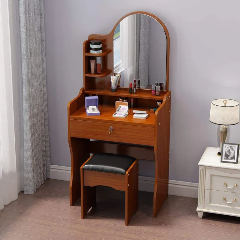 Warm wood-tone vanity with a round-top arched mirror, small open shelves, a key-lock drawer and a black padded stool