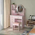 Pink vanity desk with a round mirror, open shelves, drawers and a pink padded stool, in a bedroom