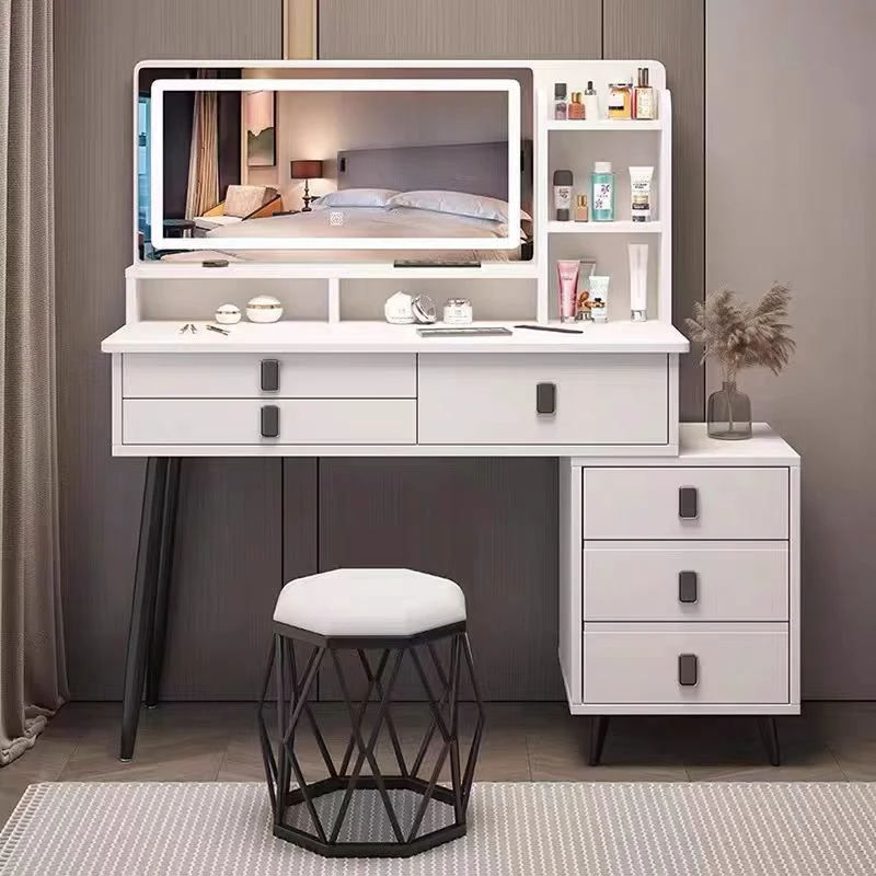 White vanity desk with a lit LED mirror, a three-drawer side cabinet and a hexagonal stool with a black lattice base