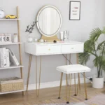 White vanity desk with a round mirror, two drawers and a padded stool, next to a potted palm