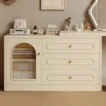 Close-up of the arched fluted-glass door and three oval-fronted drawers with round gold-tone knobs