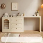 Cream cabinet with the desk top reaching out to the right, with brushes and skincare on top, beside a rug