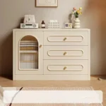 Cream cabinet from the front, with an arched fluted-glass door and three drawers
