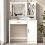 White vanity with a bulb-lit mirror, open shelves, a wide drawer and a door cabinet, beside a plant and curtains
