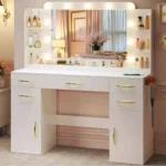 Wide white vanity with a bulb-lit mirror, drawers and door cabinets, and a hairdryer on the side holder