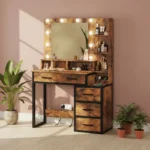 Rustic wood-look vanity with a bulb-lit mirror, a wide drawer, a three-drawer bank and a black metal frame, in a pink room
