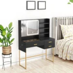 Black vanity desk with an LED mirror and a gold-tone base, with two empty picture frames on the wall above