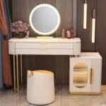 Cream vanity with a marble-look top, a round LED mirror, an oval-window cabinet and a cream stool, against a wood-panel wall
