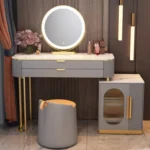 Gray vanity with a round LED mirror, an oval-window cabinet and a gray stool with a tan top