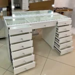 White vanity with every drawer pulled open and the glass-covered compartments, in a showroom