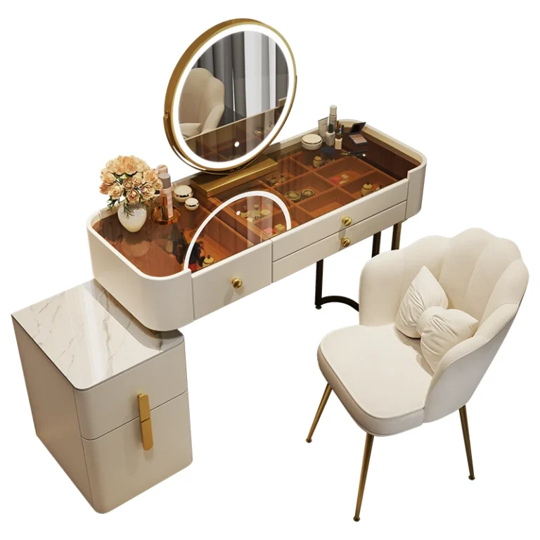 Cream vanity on a white background with a tinted glass top, a round LED mirror, a two-drawer cabinet and a scalloped chair